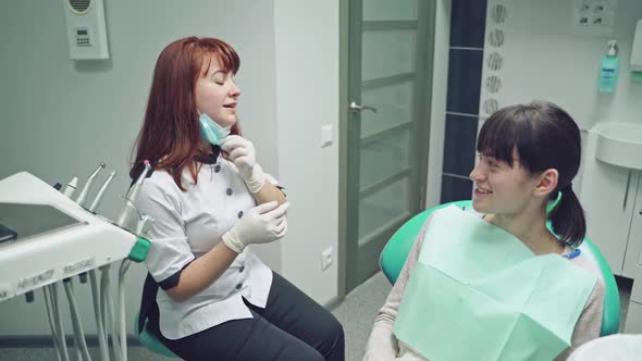 A client and the dentist are sitting in the office and talking about preventive methods
