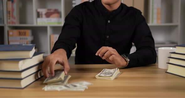 Businessman counting dollar bills cash