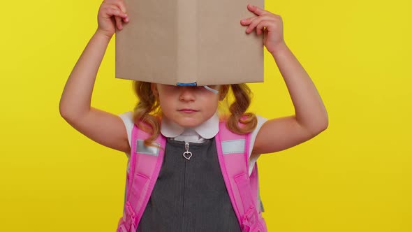 Lovely Teenage Girl Kid in School Uniform Wears Pink Backpack Peeping While Hiding Behind a Book