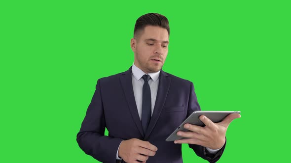 Businessman Presenting From the Tablet on a Green Screen, Chroma Key