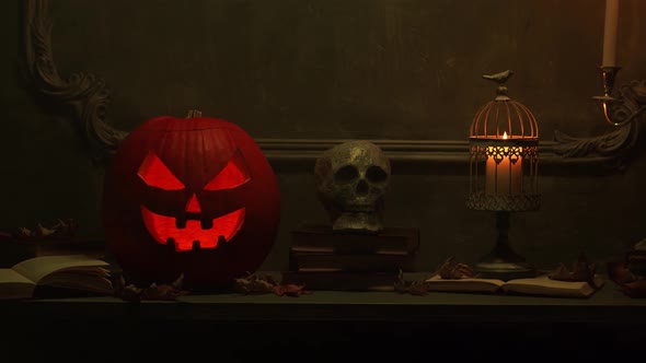 Scary laughing pumpkin and an old skull over the frightening gothic background.