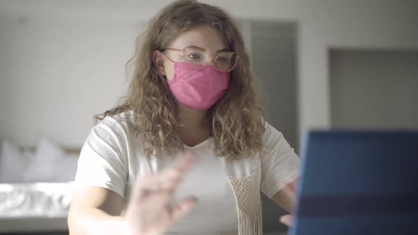 Confident Plump Woman in Covid-19 Face Mask and Eyeglasses Talking and Gesturing at Laptop Selfie