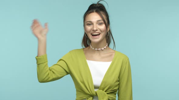 Slow Motion of Beautiful Young Woman in Stylish Clothes Saying Hi Waving at Camera Friendly in Hello