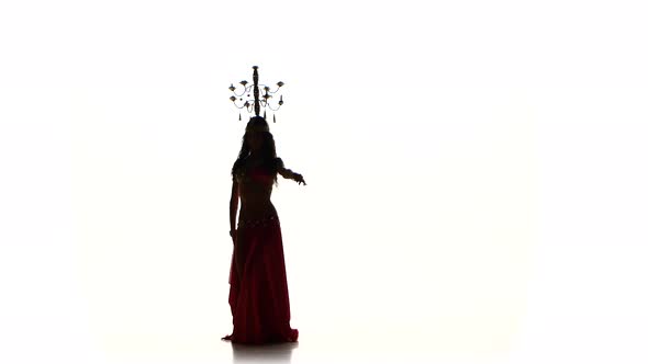 Attractive Belly Dancer Girl Dancing with Candles on Her Head, Silhouette, on White