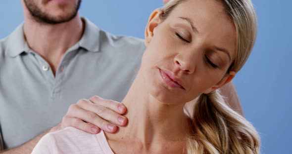 Female patient receiving neck massage from physiotherapist