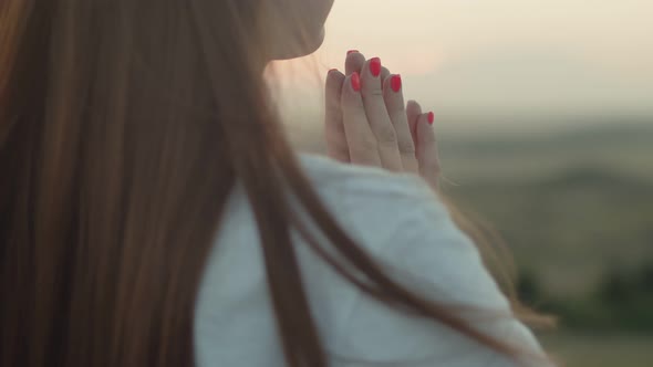 Confident White Woman Stands Outdoor and Puts Her Hands Together Closeup