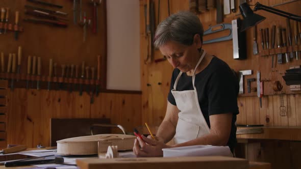 Female luthier at work in her workshop