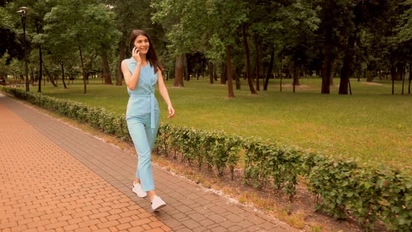 Side View Young Woman Talking By Phone on the Run