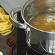 Hands Put Fettuccine Pasta in Pan of Boiling Water and Stir with Spoon - VideoHive Item for Sale