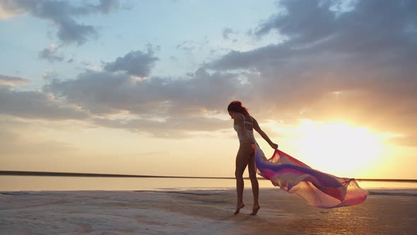 Dancing on the Beach, Woman in Bikini Is Jumping and Posing with Her Pareo