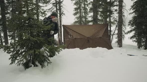 Man Building Shelter in a Snow Storm Blizzard.