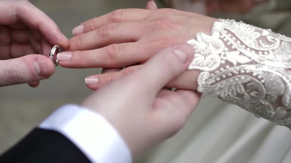 The Groom Puts the Wedding Ring on the Bride's Finger