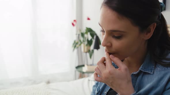 Caucasian pregnant woman about to take a pill and drink water. Shot with RED helium camera in 8K.