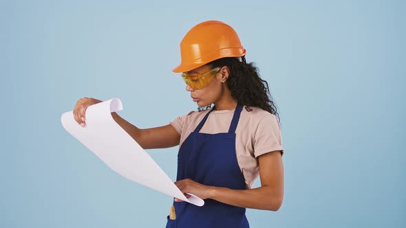 Darkskinned Girl Worker in Hard Hat Protective Goggles