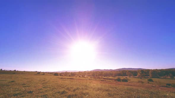  UHD Mountain Meadow Timelapse at the Summer. Clouds, Trees, Green Grass and Sun Rays Movement.