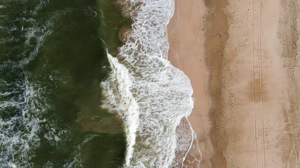 Drone Flight Over the Azure Sea with Waves and Sandy Coast