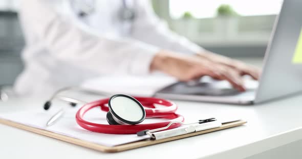 Doctor is Typing on Keyboard in Clinic Closeup