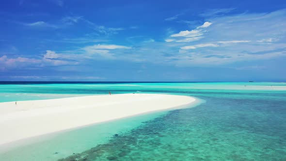 Aerial top down nature of marine resort beach break by turquoise ocean and bright sandy background o