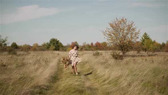 Woman Walking on a Meadow in Summer