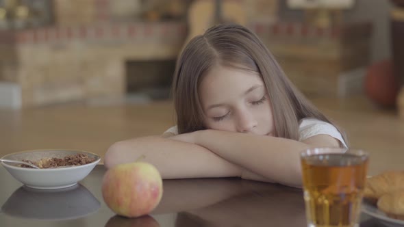 Portrait of Sleeping Kid Food on the Table and Small Girl with Long Hair Sleeping on It