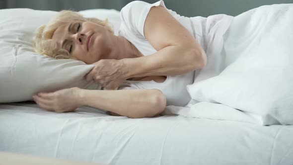 Happy Middle-Aged Female Sleeping in Bed on Orthopedic Mattress, Health