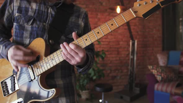 Portrait of Young Man Musician with Long Red Hair Playing Electric Guitar at Home Slow Motion Close