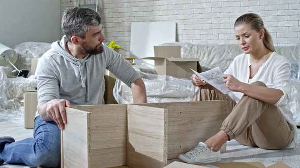 Man and Woman Assembling Shelf alt