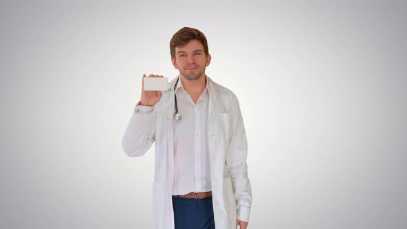 Smiling Male Doctor Walking and Advertising Pills Looking at Camera on Gradient Background.