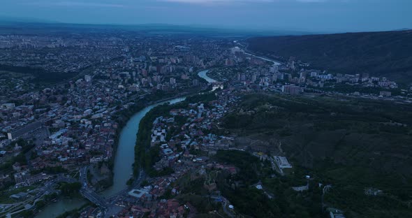Aerial view of Tbilisi old town buildings and Narikala fortress landmark on hill