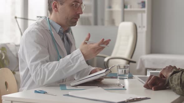 Radiologist Talking to Army Officer at Appointment alt