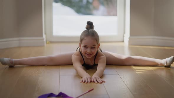 Front View Portrait of Confident Motivated Teenage Gymnast Looking at Camera Bending Forward on