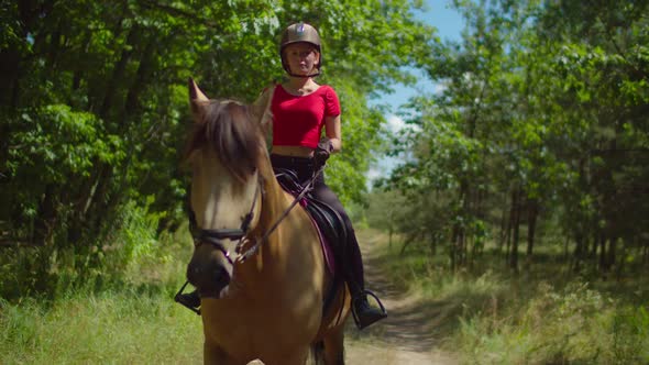Teenage Girl Jockey Riding Horseback in Nature