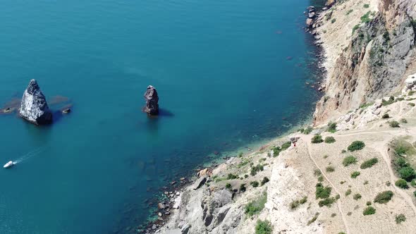 Aerial View From Above on Calm Azure Sea and Volcanic Rocky Shores