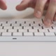 Male Hands Typing on a White Computer Keyboard - VideoHive Item for Sale