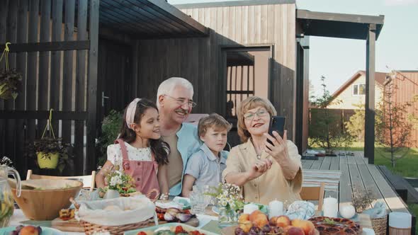 Woman Taking Selfie with Family