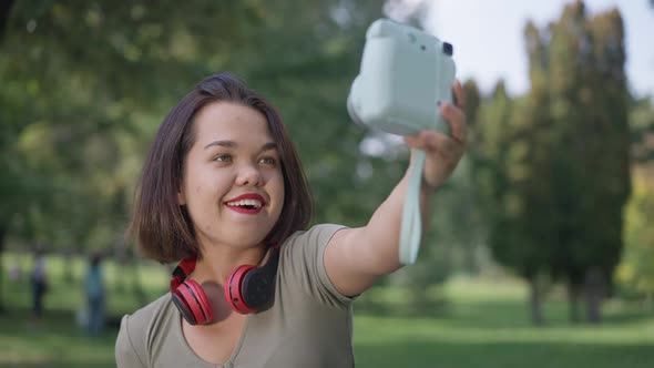 Carefree Little Woman Taking Selfie on Camera Resting in Summer Park Outdoors