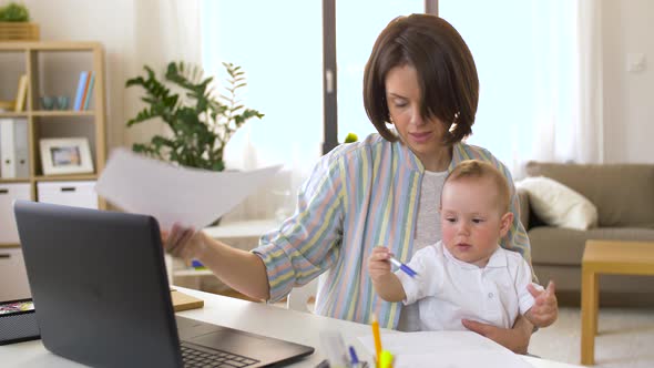 Working Mother with Baby Boy at Home Office 