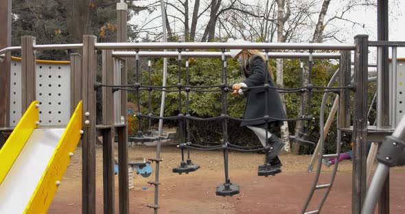 Girl Child Playing in the Park with Her Father Wearing Mask