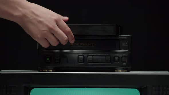 Putting Video Cassette Into Recorder