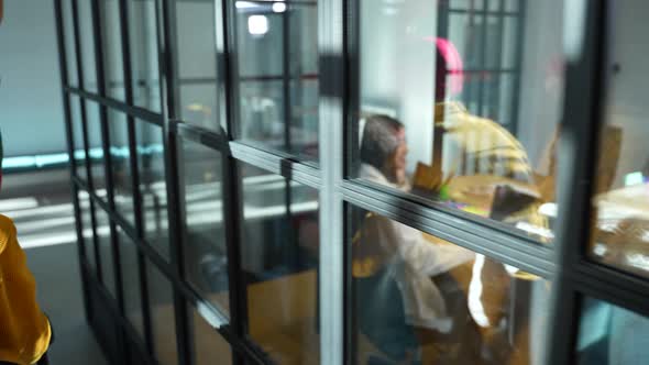 Joyful Colleagues Having Fun Riding Chair Indoors