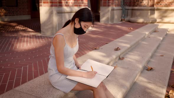 Asian female college student working on her homework