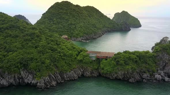 Aerial View Building Lost in Deep Jungle on Rocky Island