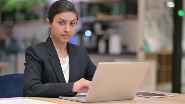 Attractive Indian Businesswoman with Laptop Showing No Sign 