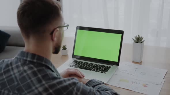 Man with Laptop with Blank Green Screen