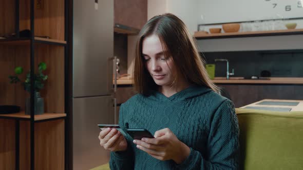 Young Woman Shopping Online on Sofa at Home. Smiling Woman Online Banking Using Smartphone Shopping