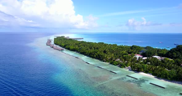 Tropical above clean view of a paradise sunny white sand beach and aqua blue ocean background in colorful