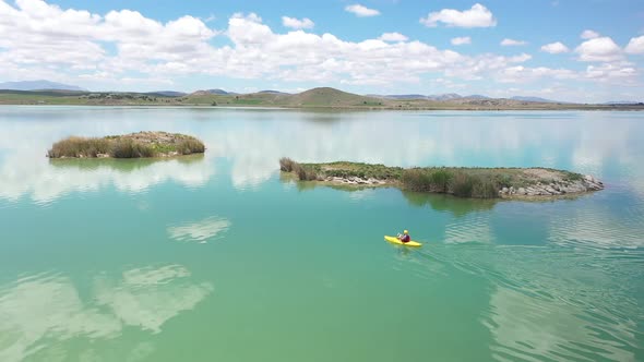 Young Man Canoeing On The Lake Aerial View