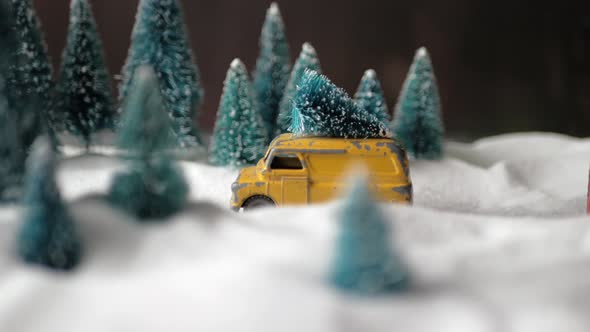 Winter Forest Miniature with a Small Yellow Toy Car with a Christmas Tree on the Roof, Double-decker