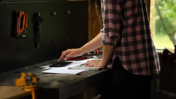 Female business owner using digital tablet in workshop