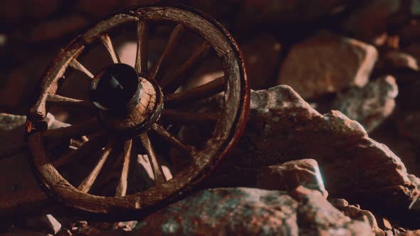 Old Wooden Wheel on Rocks